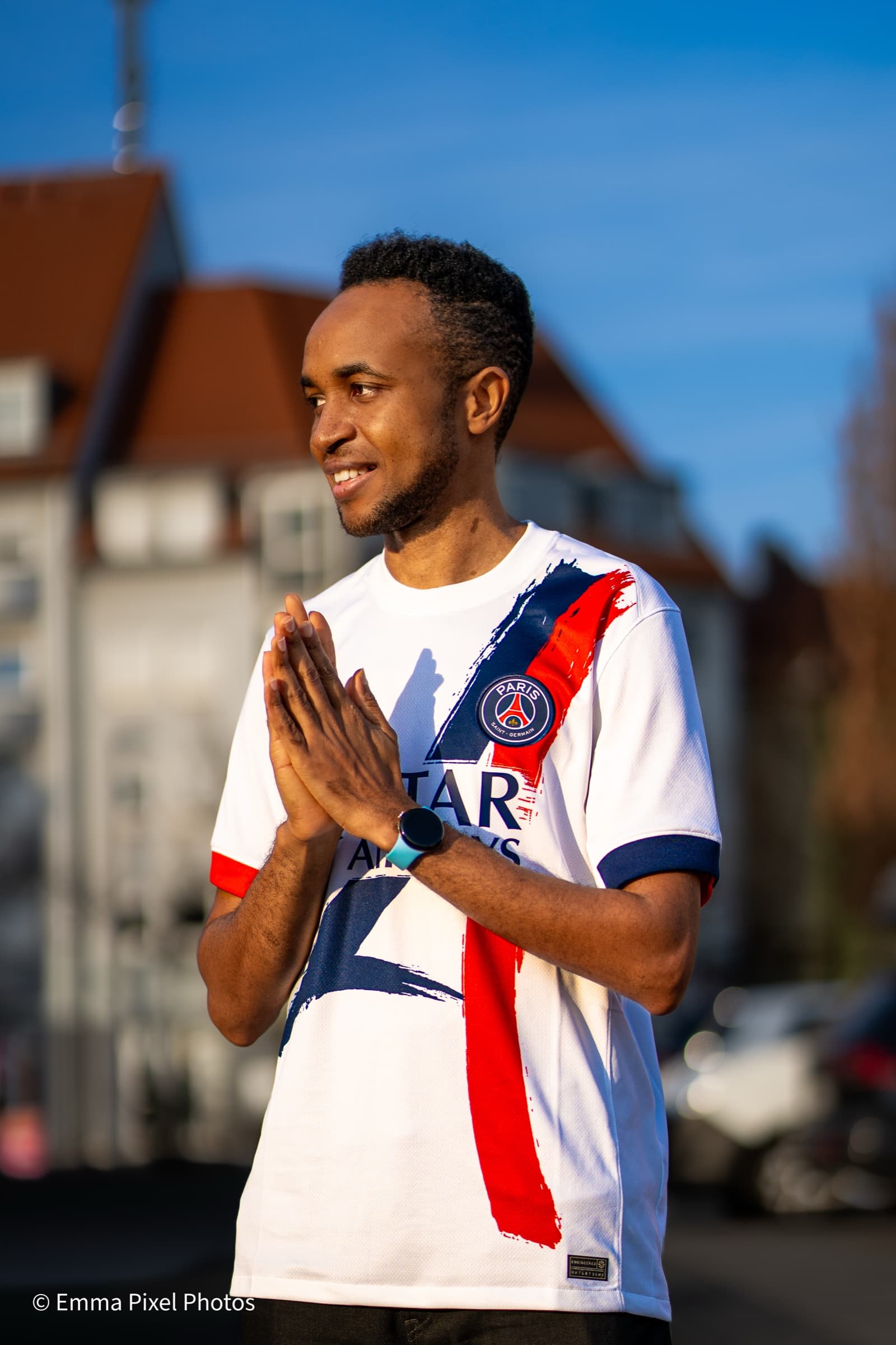 PSG jersey portrait, hands clasped, golden hour