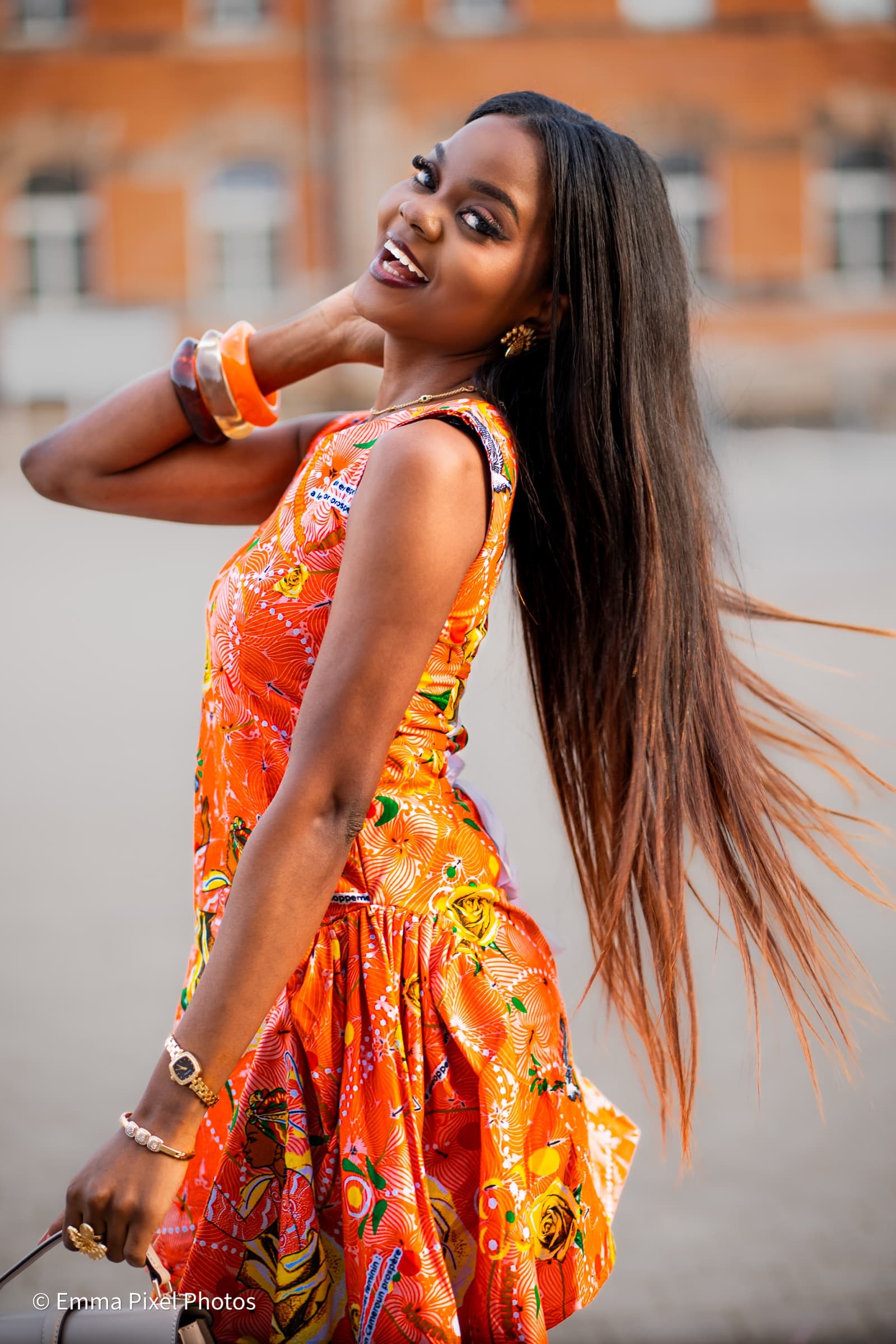 Orange-print dress, hair flowing in golden hour