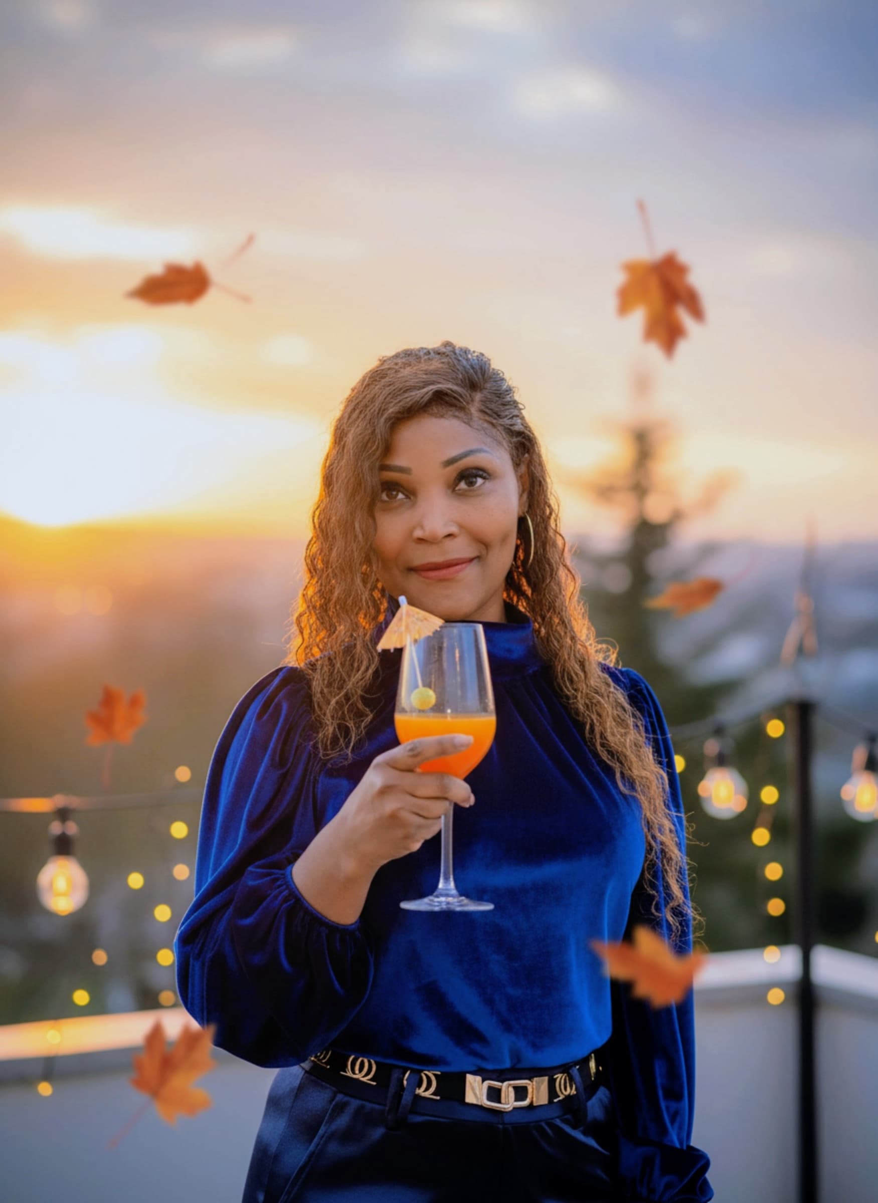 Blue velvet at sunset, wine glass and falling autumn leaves