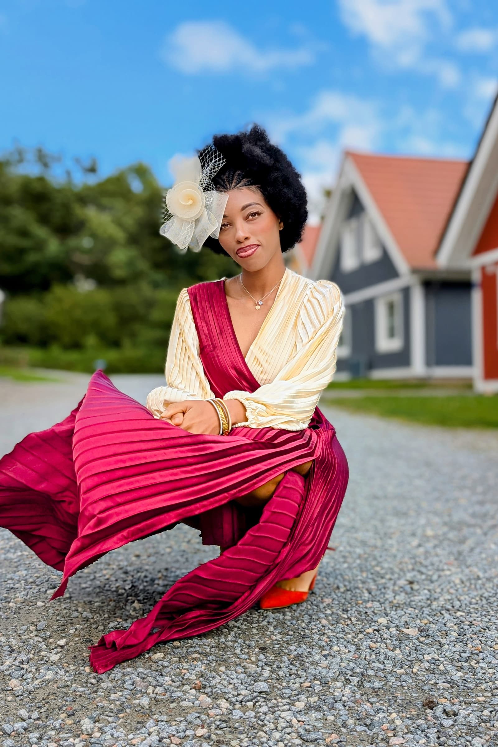 Burgundy pleated gown in motion, summer afternoon