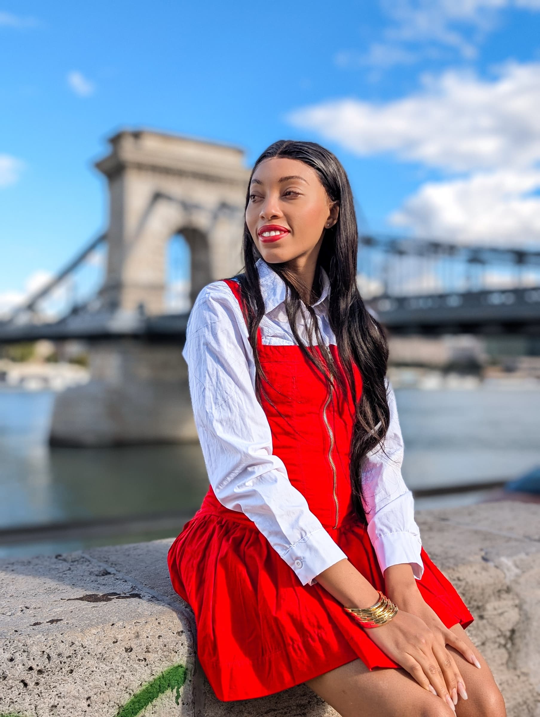Red pinafore dress in front of the Budapest Chain Bridge